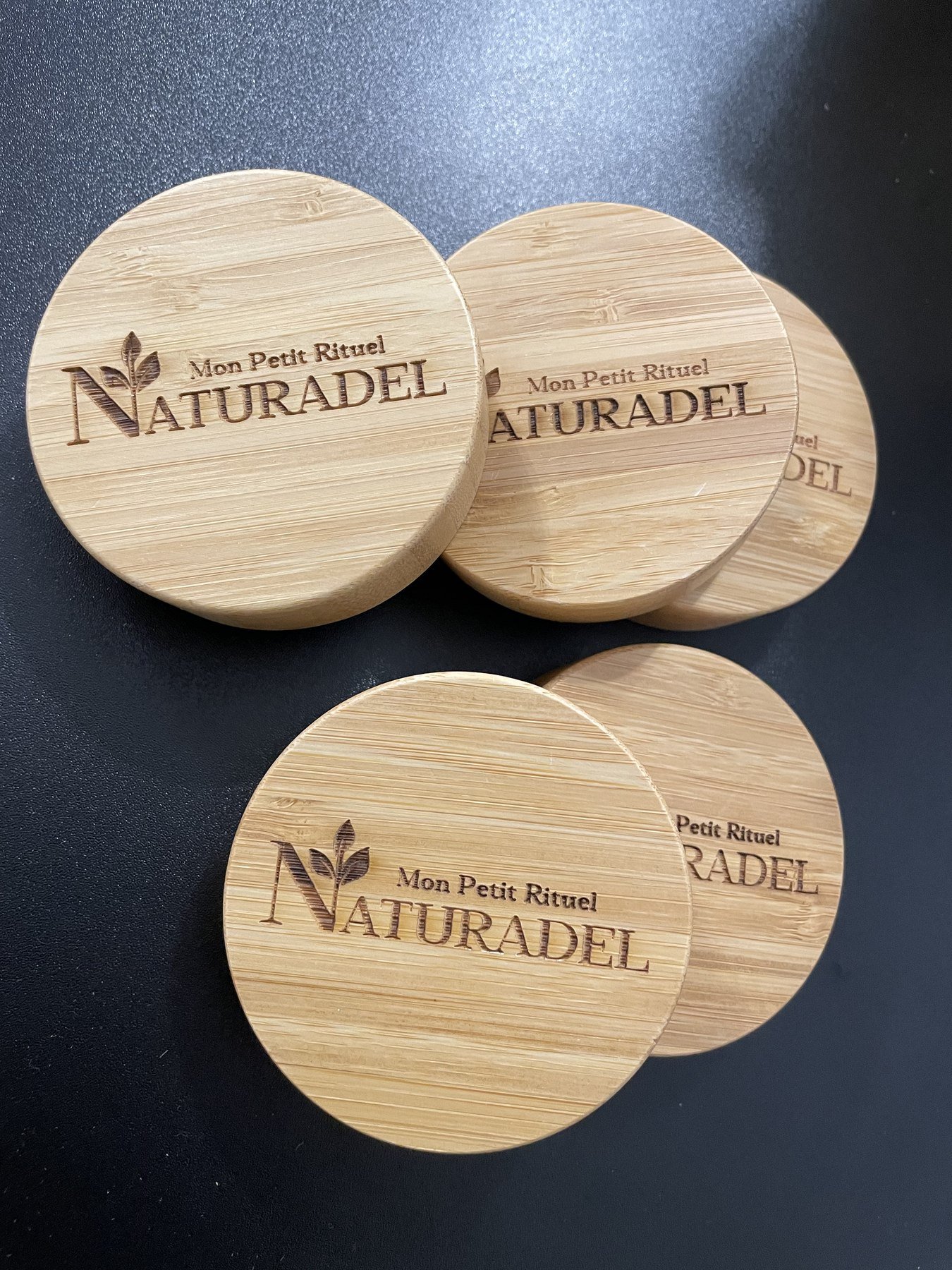 Couvercles en bambou gravés au logo d’une marque de cosmétique