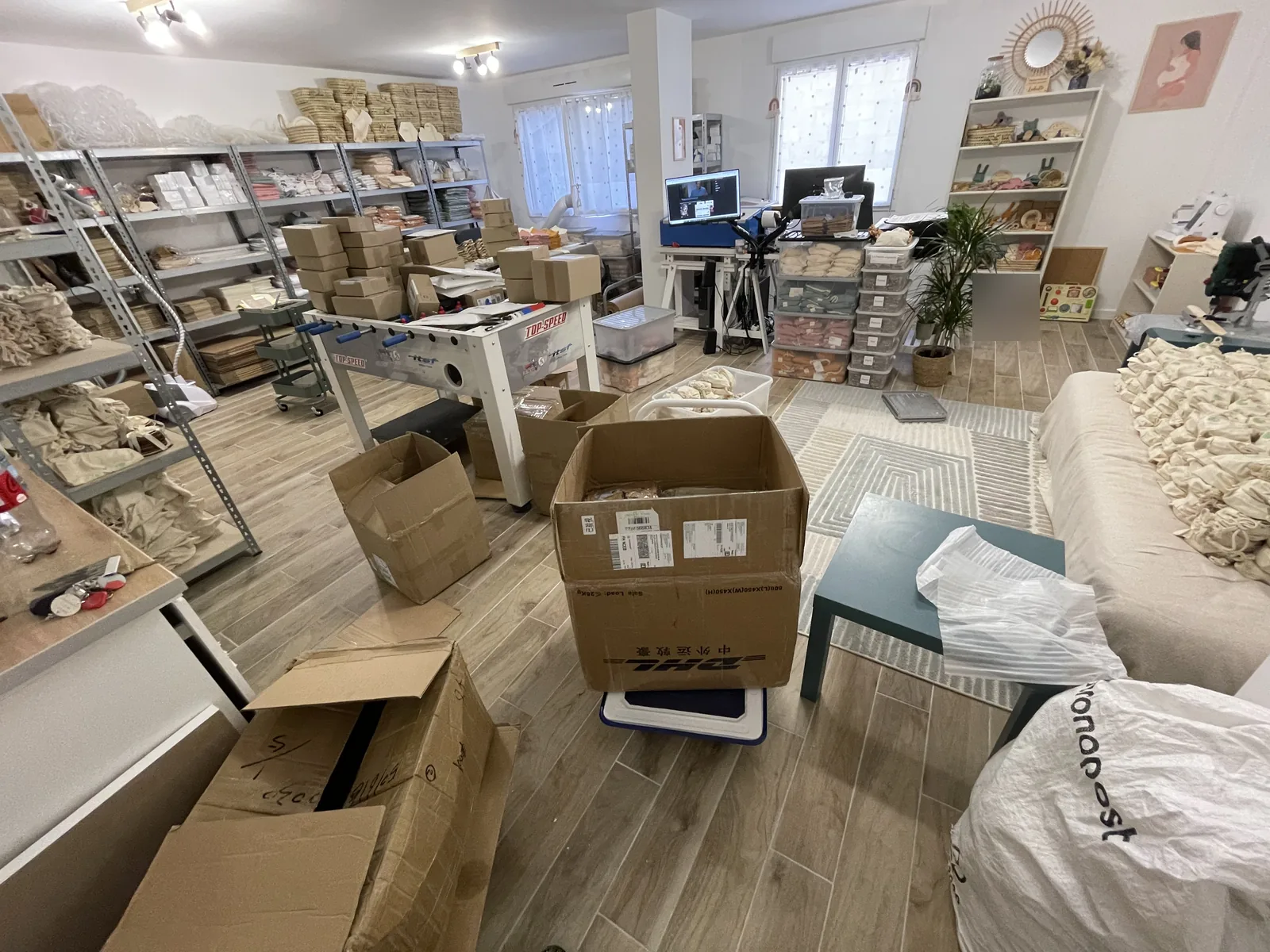 Vue d’ensemble d’un atelier de e-commerce artisanal avec rayonnages et poste de travail