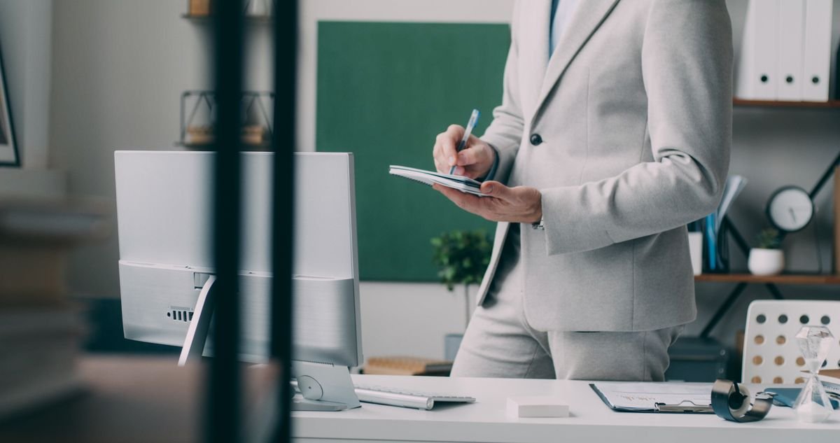 Un homme d'affaires concentré dans un bureau moderne, prenant des notes devant