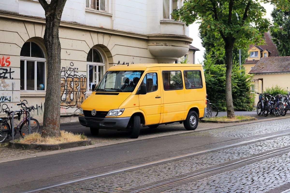 Frais de port : le paramétrage qui protège votre marge Une camionnette jaune vif garée dans une rue pavée de Kassel, en Allemagne
